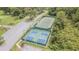 An impressive aerial view showcasing the community tennis and pickleball courts, ideal for staying active and enjoying friendly competition at 9823 Rolling Cir, San Antonio, FL 33576
