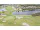 A breathtaking aerial view showcases the lush green golf course and sparkling lake, perfect for nature lovers and golf enthusiasts at 9823 Rolling Cir, San Antonio, FL 33576
