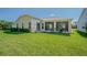 A lovely view of the well-maintained backyard and screened-in porch, perfect for outdoor relaxation at 9823 Rolling Cir, San Antonio, FL 33576