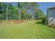 A large backyard with a privacy fence, lots of green space, mature trees and well maintained landscape at 9823 Rolling Cir, San Antonio, FL 33576