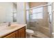 The bathroom has tiled walls and floors and includes a glass-doored shower with built-in seat at 9823 Rolling Cir, San Antonio, FL 33576