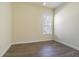 Neutral bedroom with hard surface floors and a window at 9823 Rolling Cir, San Antonio, FL 33576