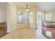 Bright dining area featuring tile floors, large windows, and sliding glass doors to the screened patio at 9823 Rolling Cir, San Antonio, FL 33576