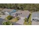 Charming single-story home with a well-manicured lawn, mature trees, and an attached two-car garage at 9823 Rolling Cir, San Antonio, FL 33576