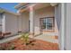 An inviting front entrance featuring a tiled porch and well-manicured flower beds, creating a warm and welcoming ambiance at 9823 Rolling Cir, San Antonio, FL 33576