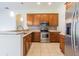 Kitchen with stainless steel appliances, granite countertops, and tile flooring at 9823 Rolling Cir, San Antonio, FL 33576