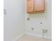 This is a basic laundry room with tile floor and a cabinet mounted on the wall at 9823 Rolling Cir, San Antonio, FL 33576