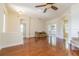An open living area features wood floors and access to the patio with views of the back yard at 9823 Rolling Cir, San Antonio, FL 33576