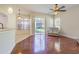 Open-concept living room area featuring wood floors and a view of the backyard at 9823 Rolling Cir, San Antonio, FL 33576