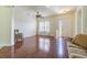 A well lit living room features wood floors, large windows and an exterior door to the front yard at 9823 Rolling Cir, San Antonio, FL 33576