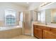 Beautiful main bathroom features a luxurious soaking tub, glass shower and a double vanity at 9823 Rolling Cir, San Antonio, FL 33576