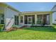 Back patio featuring a screened in lanai, lush landscaping and beautiful backyard at 9823 Rolling Cir, San Antonio, FL 33576