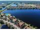 Expansive aerial showcasing the community, lake, and colorful townhome exteriors at 9828 Lake Chase Island Way # 0, Tampa, FL 33626