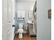 Clean bathroom with blue walls, white toilet, sink with gray cabinets, and decorative mirror at 9828 Lake Chase Island Way # 0, Tampa, FL 33626