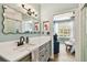 Stylish bathroom with a modern vanity, unique mirror, and walk-in shower, adjoining a bedroom at 9828 Lake Chase Island Way # 0, Tampa, FL 33626