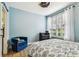 Comfortable bedroom featuring light blue walls, a ceiling fan, and wood-look floors at 9828 Lake Chase Island Way # 0, Tampa, FL 33626