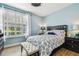 Serene bedroom with blue walls, wood-look floors, and a comfortable bed at 9828 Lake Chase Island Way # 0, Tampa, FL 33626