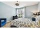 Inviting bedroom with cool blue walls, wood-look flooring, and a decorative ceiling fan at 9828 Lake Chase Island Way # 0, Tampa, FL 33626