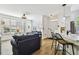 Open-concept living area featuring stylish furniture, a kitchen with counter seating, and bright, neutral decor at 9828 Lake Chase Island Way # 0, Tampa, FL 33626