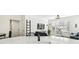 Open concept living area with modern decor, light-colored flooring, and ample natural light at 9828 Lake Chase Island Way # 0, Tampa, FL 33626