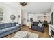 Bright and airy living room showcasing hardwood floors, comfortable seating, and an open layout with kitchen access at 9828 Lake Chase Island Way # 0, Tampa, FL 33626