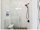 Modern shower featuring subway tile, glass door, pebble floor, and built-in niche with plants at 9828 Lake Chase Island Way # 0, Tampa, FL 33626