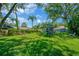 Lush green backyard featuring a playground, mature trees, and plenty of space to play at 1007 Morfield Ln, Brandon, FL 33511