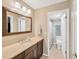Well-lit bathroom featuring double sinks and a separate door for the toilet at 1007 Morfield Ln, Brandon, FL 33511