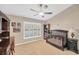 Cozy bedroom featuring a crib, plantation shutters, and ceiling fan at 1007 Morfield Ln, Brandon, FL 33511
