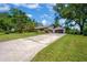 Home featuring a spacious driveway, lush landscaping, and a two-car garage at 1007 Morfield Ln, Brandon, FL 33511