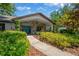 Inviting home exterior with stone accents, blue double doors, and lush landscaping at 1007 Morfield Ln, Brandon, FL 33511
