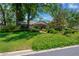 Charming single-story home featuring lush landscaping, mature trees, and a stone-accented facade at 1007 Morfield Ln, Brandon, FL 33511