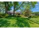 Well-manicured front yard with lush landscaping and a charming home exterior at 1007 Morfield Ln, Brandon, FL 33511