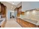Spacious kitchen with custom cabinets, tile backsplash, granite countertops, and stainless steel refrigerator at 1007 Morfield Ln, Brandon, FL 33511