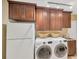 Convenient laundry room featuring washer, dryer, and ample cabinet space at 1007 Morfield Ln, Brandon, FL 33511