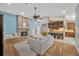 Open-concept living room featuring a brick fireplace, hardwood floors, and a view of the kitchen at 1007 Morfield Ln, Brandon, FL 33511