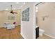 Spacious living room leading to a half-bathroom with a ceiling fan at 1007 Morfield Ln, Brandon, FL 33511