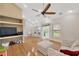 Gathering room features a ceiling fan, wood floors, and a large window for natural light at 1007 Morfield Ln, Brandon, FL 33511