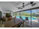 Relaxing covered patio with seating area overlooking a sparkling swimming pool at 1007 Morfield Ln, Brandon, FL 33511