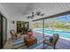 Covered patio with comfortable seating, ceiling fans, and views of the inviting pool area at 1007 Morfield Ln, Brandon, FL 33511