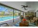 An expansive screened-in pool area with brick pavers, ceiling fans and outdoor furniture at 1007 Morfield Ln, Brandon, FL 33511