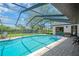Screened-in pool area with chairs and floats, offering a relaxing outdoor experience at 1007 Morfield Ln, Brandon, FL 33511