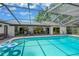 Inviting screened-in pool with patio furniture for outdoor dining and entertaining at 1007 Morfield Ln, Brandon, FL 33511