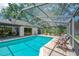 Inviting screened-in pool area with blue-tiled pool and brick pavers, perfect for outdoor relaxation at 1007 Morfield Ln, Brandon, FL 33511