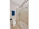 Modern shower with glass doors, multiple showerheads, and tiled walls at 1007 Morfield Ln, Brandon, FL 33511