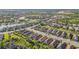 Expansive aerial view of a residential community with lush greenery, serene lakes and well-kept homes at 10450 Highland Park Pl, Palmetto, FL 34221