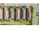 Scenic aerial view showcasing well-maintained homes with tiled roofs, lush landscaping and pond views at 10450 Highland Park Pl, Palmetto, FL 34221