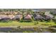 Picturesque aerial view of homes with screened lanais overlooking lush greenery and tranquil waterfront at 10450 Highland Park Pl, Palmetto, FL 34221
