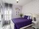 Cozy bedroom with soft violet walls, white wood accents, and stylish contemporary decor at 10450 Highland Park Pl, Palmetto, FL 34221