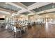 A spacious community center features elegant chandeliers, dark wood flooring, and ample seating at 10450 Highland Park Pl, Palmetto, FL 34221